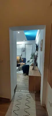 a hallway leading to a living room with a blue ceiling at Apartman Jereza Prijedor in Prijedor