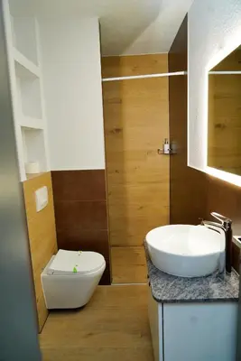 a bathroom with a white toilet and a sink at Swiss Apartmani in Banja Luka
