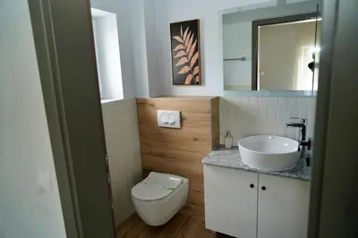 a bathroom with a toilet and a sink at Swiss Apartmani in Banja Luka
