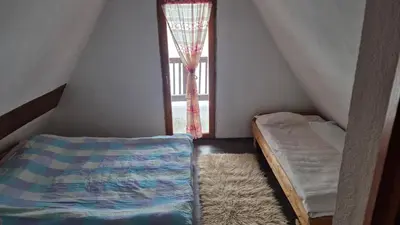 a small room with a bed and a window at VilaBellavistasmjestaj in Vlasic
