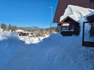 a pile of snow next to a building at VilaBellavistasmjestaj in Vlasic