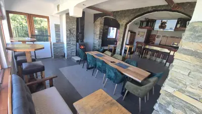 a dining room with wooden tables and chairs at VilaBellavistasmjestaj in Vlasic