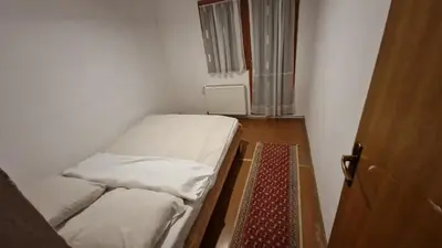 a small room with two beds and a door at VilaBellavistasmjestaj in Vlasic