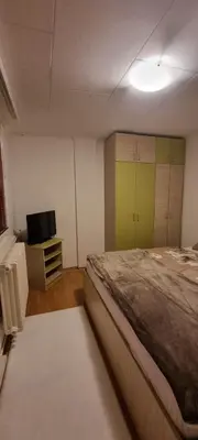 a bedroom with a bed and a flat screen tv at Apartman Borik Banjaluka in Banja Luka