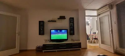 a living room with a flat screen tv on a cabinet at Apartman Borik Banjaluka in Banja Luka