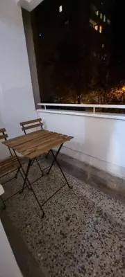 a wooden bench sitting on top of a room with a window at Apartman Borik Banjaluka in Banja Luka
