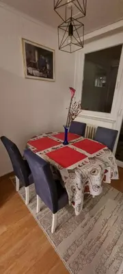 a dining room table with a red and white table cloth at Apartman Borik Banjaluka in Banja Luka