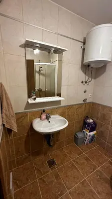 a bathroom with a sink and a mirror at Valluna Studio Apartman Kupres in Kupres