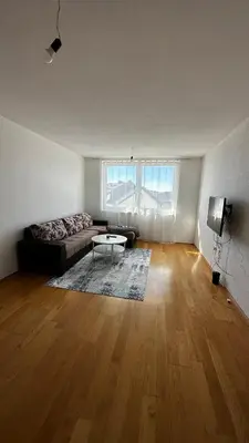 a living room with a couch and a table at Valluna Studio Apartman Kupres in Kupres