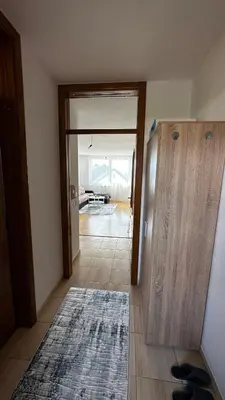 a hallway with a door and a rug on the floor at Valluna Studio Apartman Kupres in Kupres
