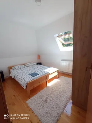 a small bedroom with a bed and a window at Druga priča in Vlasic