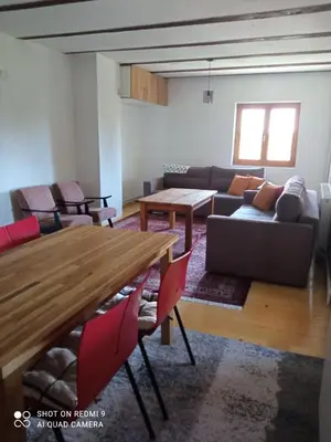 a living room with a table and a couch at Druga priča in Vlasic