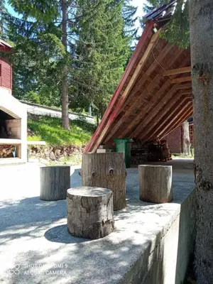 a group of logs sitting next to a building at Druga priča in Vlasic