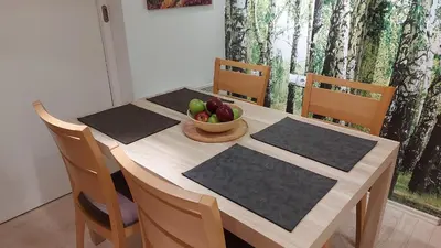 a wooden table with a bowl of fruit on it at Apartment XYZ Vlašić in Vlasic