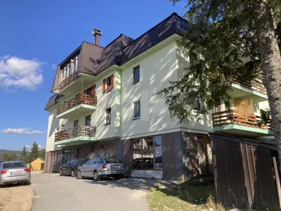 a building with cars parked in front of it at Apartment XYZ Vlašić in Vlasic