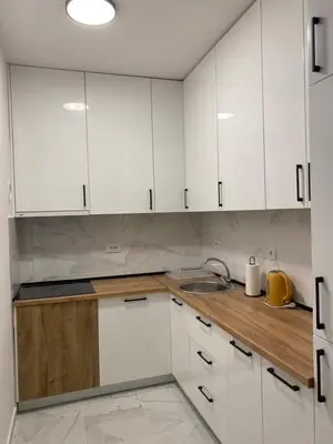 a kitchen with white cabinets and a sink at Mona in Banja Luka