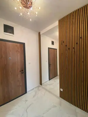 a large room with a door and a chandelier at Mona in Banja Luka