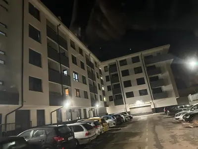 a parking lot with cars parked in front of a building at Apartman MRL Cavic in Banja Luka