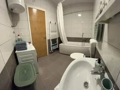 a bathroom with a sink and a toilet and a tub at Apartment Mejdan in Tuzla