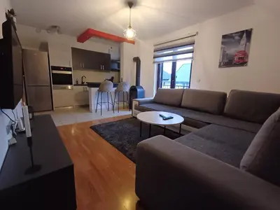 a living room with a couch and a table at Vikendica Mila in Kupres