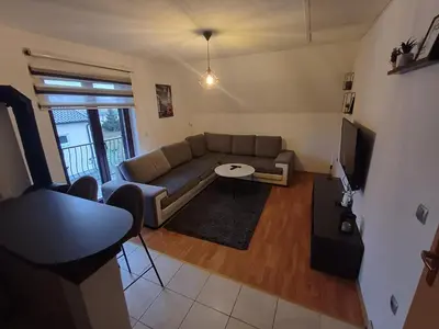 a living room with a couch and a table at Vikendica Mila in Kupres