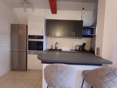 a kitchen with a refrigerator and a counter top at Vikendica Mila in Kupres