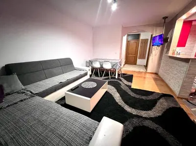 a living room with a couch and a table at MD Tuzla in Tuzla
