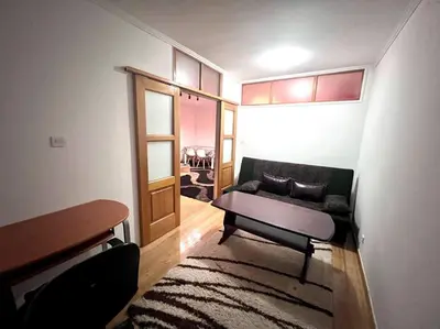 a living room with a couch and a table at MD Tuzla in Tuzla