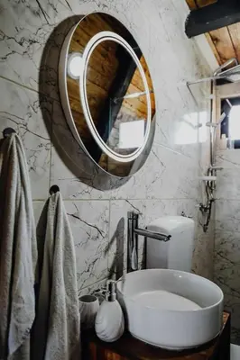 a bathroom with a sink and a mirror at Under Sky House - Vikendica - Manjača in Ključ