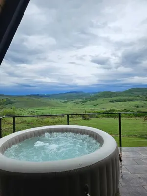 a hot tub with a view of the mountains at Under Sky House - Vikendica - Manjača in Ključ