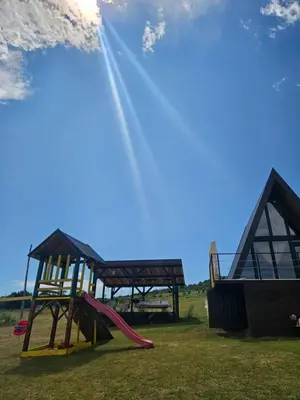 a playground with a slide and a play structure at Under Sky House - Vikendica - Manjača in Ključ