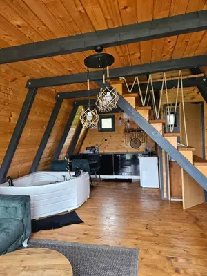a large living room with a tub in the ceiling at Under Sky House - Vikendica - Manjača in Ključ