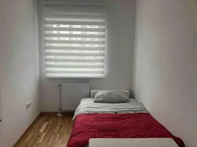 a bed in a white room with a window at Apartman Vrbas 1 + Podzemna garaza in Banja Luka
