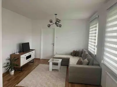 a living room with a couch and a table at Apartman Vrbas 1 + Podzemna garaza in Banja Luka