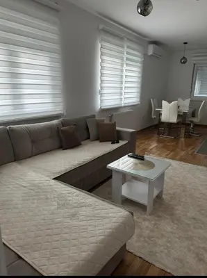 a living room with a couch and a table at Apartman Vrbas 1 + Podzemna garaza in Banja Luka
