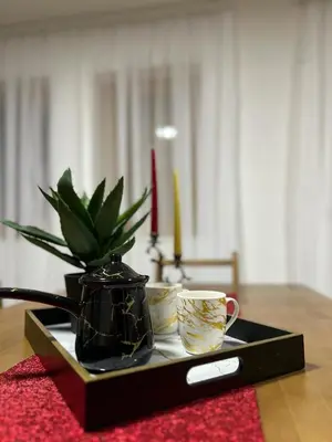 a tray with a plant and two cups on a table at Villa Dejana Vlašić in Šišava