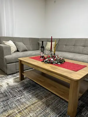 a living room with a couch and a table with a candle at Villa Dejana Vlašić in Šišava