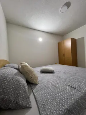 a bedroom with a large bed with two pillows on it at Villa Dejana Vlašić in Šišava