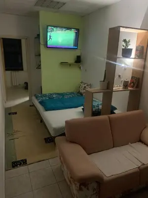 a living room with a couch and a flat screen tv at Smjestaj in Doboj