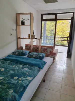 a bedroom with a large bed with a fish blanket at Smjestaj in Doboj