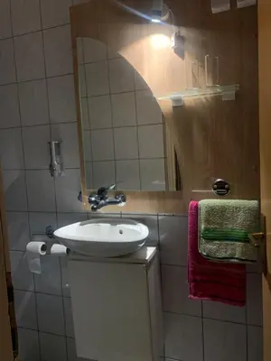 a bathroom with a sink and a mirror at Smjestaj in Doboj