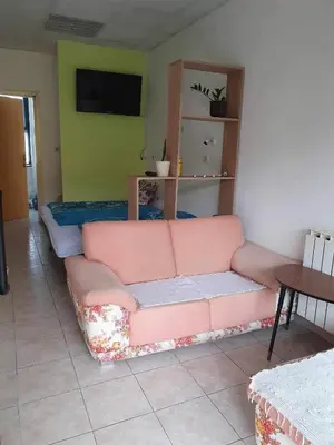 a living room with a pink couch in a room at Smjestaj in Doboj