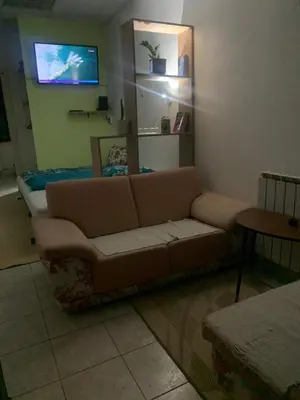 a living room with a couch and a tv at Smjestaj in Doboj
