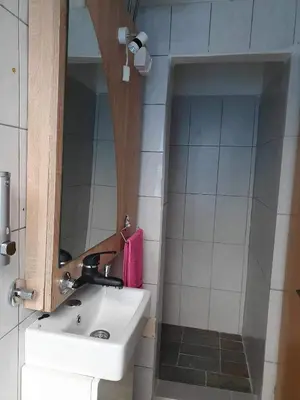 a bathroom with a sink and a mirror at Smjestaj in Doboj
