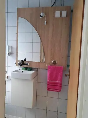 a bathroom with a sink and a pink towel at Smjestaj in Doboj