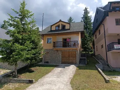 a house with a tree in front of it at Vlašić, Babanovac, vikendica Ante in Vlasic
