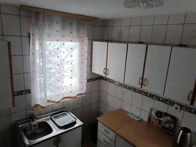 a small kitchen with a sink and a window at Vlašić, Babanovac, vikendica Ante in Vlasic