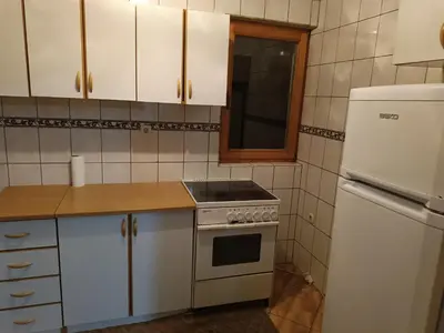 a kitchen with a stove and a refrigerator at Vlašić, Babanovac, vikendica Ante in Vlasic