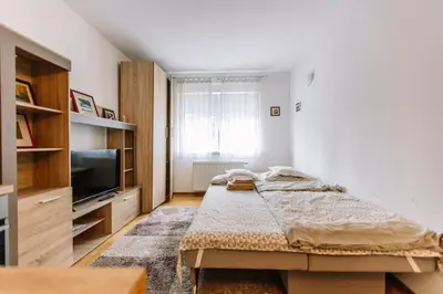 a bedroom with a bed and a flat screen tv at Studio Apartmani Donnie in Livno