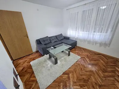 a living room with a couch and a table at Apartman Capital Novi Grad in Bosanski Novi